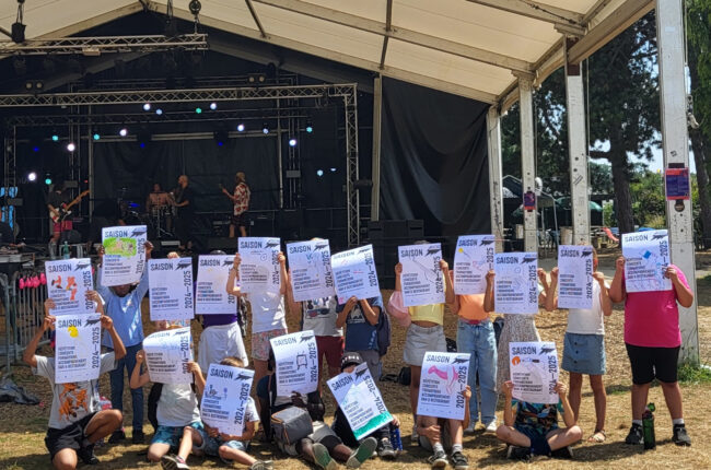 Les enfants sont chacun derrière l'affiche qu'ils ont dessinée